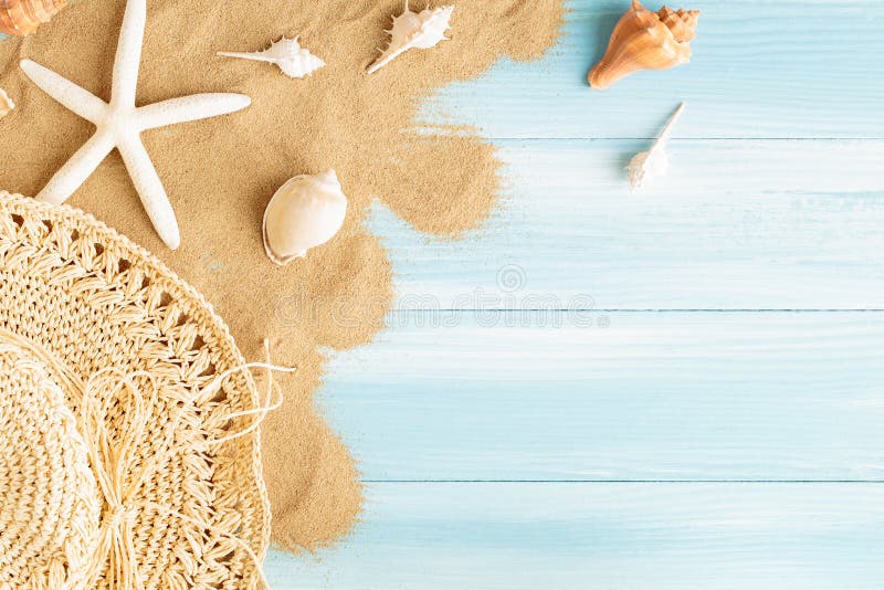 Top view of sea straw hat and sea shells on the sea sand on a blue wooden background, Summer concept on empty blue wood floor and royalty free stock images Top view of sea straw hat and sea shells on the sea sand on a blue wooden background, Summer concept on empty blue wood floor and royalty free stock images