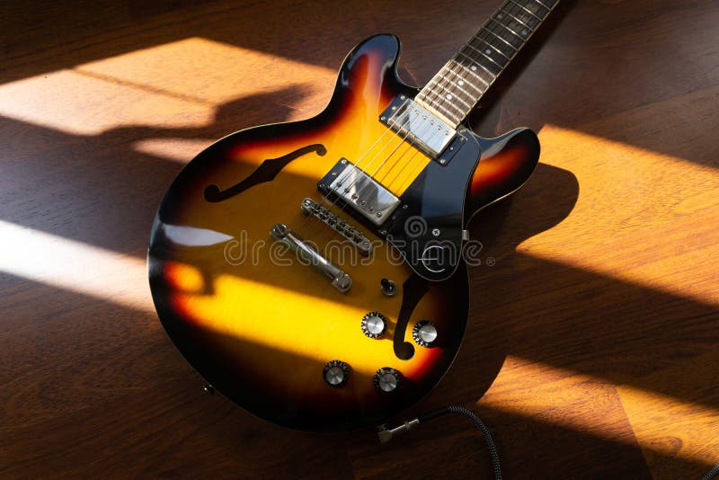 Top View of a Semiacoustic Guitar Covered with Sunlight Stock Photo