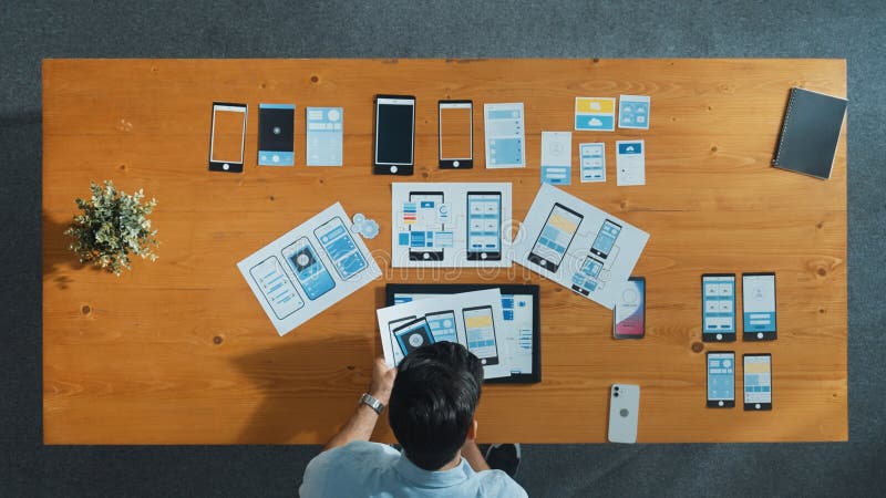 Top view of skilled developer walking and placing Ux Ui software. Convocation. stock photography