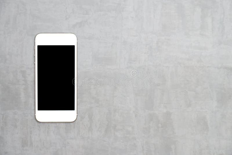 Top view smartphone mock up template with black screen on cement table. royalty free stock photography