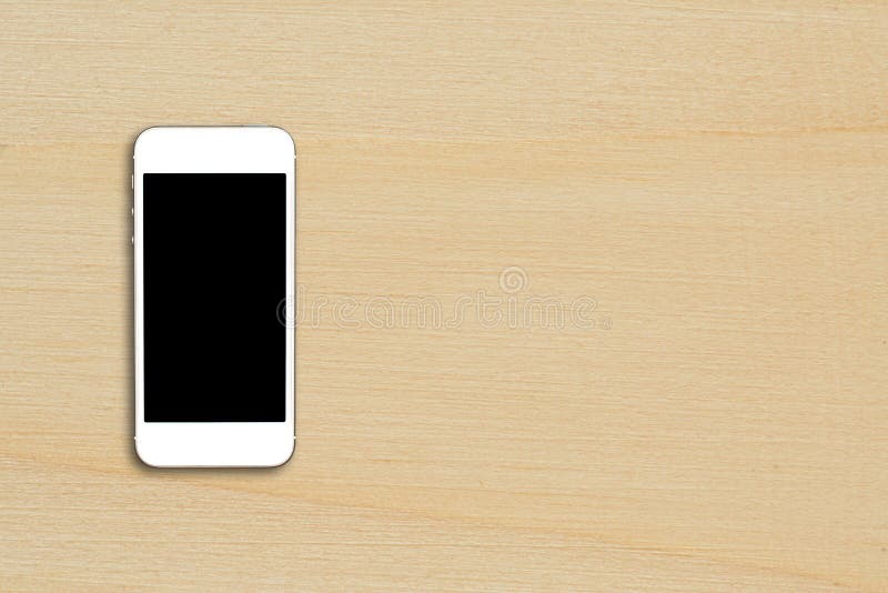 Top view smartphone mock up template with black screen on wooden table with copyspace. royalty free stock photos
