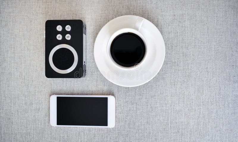 Top view smartphone mockup, a cup of black coffee and analog radio receiver, digital NOMAD, freelancer workplace or online stock photography