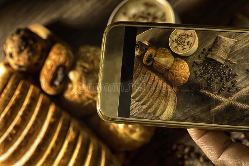 Top View-smartphone taking photo homemade bread stack placed on table in kitchen with morning sunlight consists of bread slices royalty free stock image