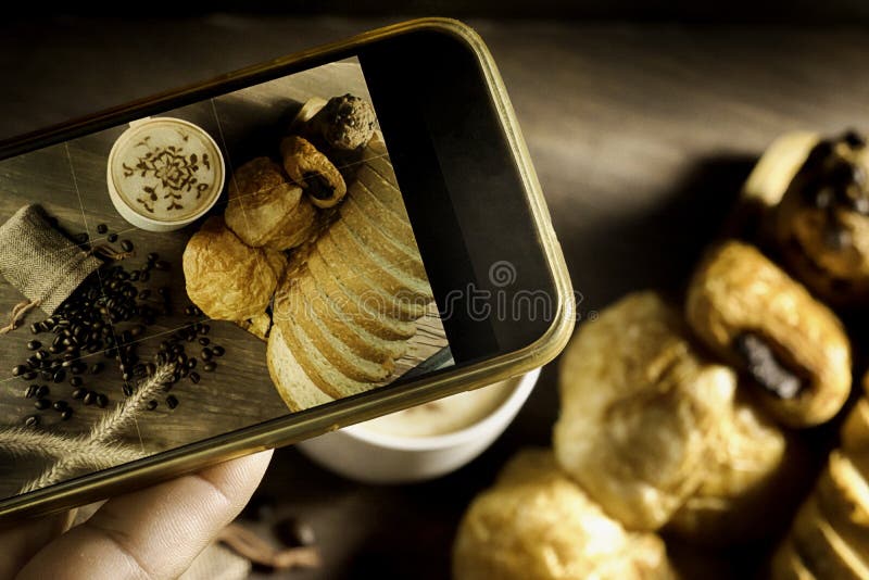 Top View-smartphone taking photo homemade bread stack placed on table in kitchen with morning sunlight consists of bread slices royalty free stock photos
