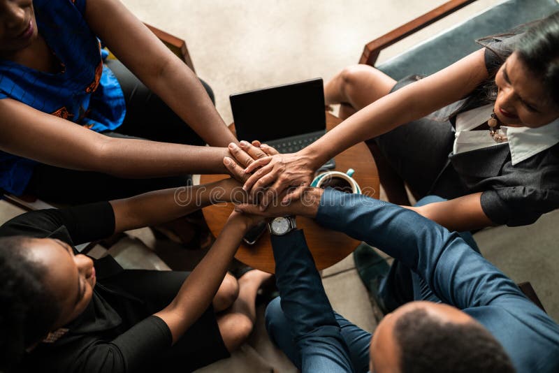 Top view of black african business team with hands stacked together in unity and trust