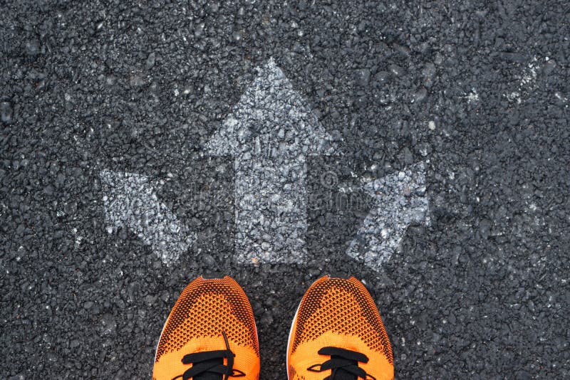 Top view of sport shoes on the road with arrows royalty free stock image Top view of sport shoes on the road with arrows royalty free stock image