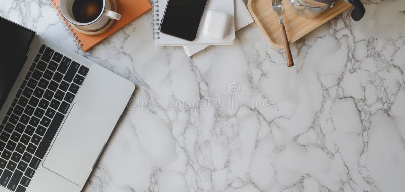 Top view of stylish workspace with laptop computer and office supplies on marble desk royalty free stock photography Top view of stylish workspace with laptop computer and office supplies on marble desk royalty free stock photography
