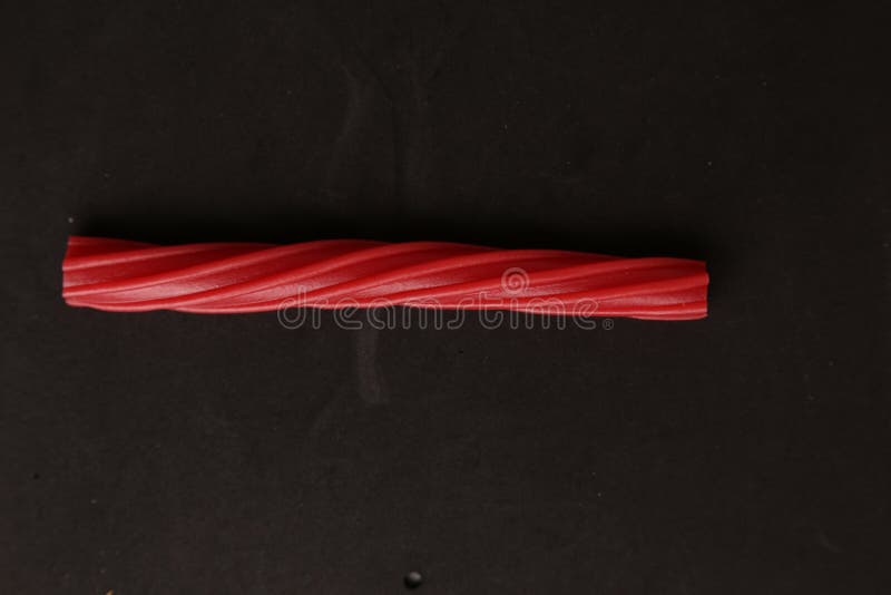 Top View of Sweet Red Licorice Isolated on a Black Surface Stock Photo