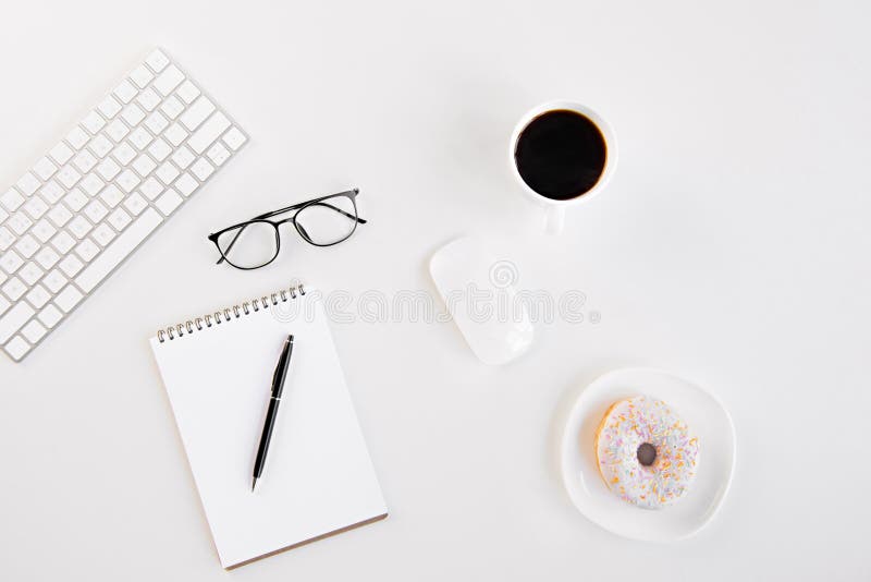 Top view of tasty croissant on plate, blank notebook with pen