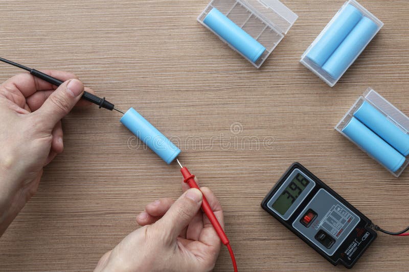 Top view of a technician's hands using a multimeter to test voltage royalty free stock image