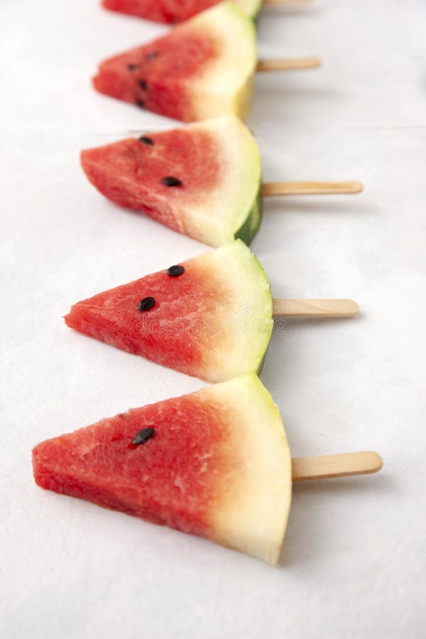 A top view of triangular cut popsicle watermelons on a white background. Triangular cut watermelon stock images, royalty-free photos and pictures