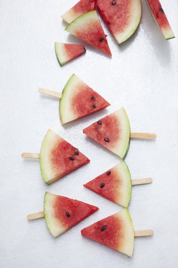 A top view of triangular cut popsicle watermelons on a white background. Triangular cut watermelon stock images, royalty-free photos and pictures