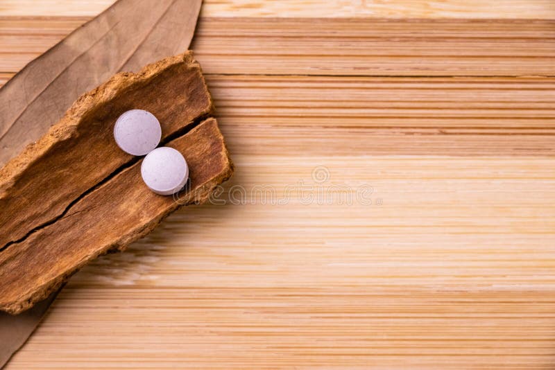 Top View of Two White Ayurvedic Medicines with Cinnamon Stick and Bay Leaf  on Wooden Background. Ayurveda Concept Stock Image - Image of ayurveda,  mode: 171305473