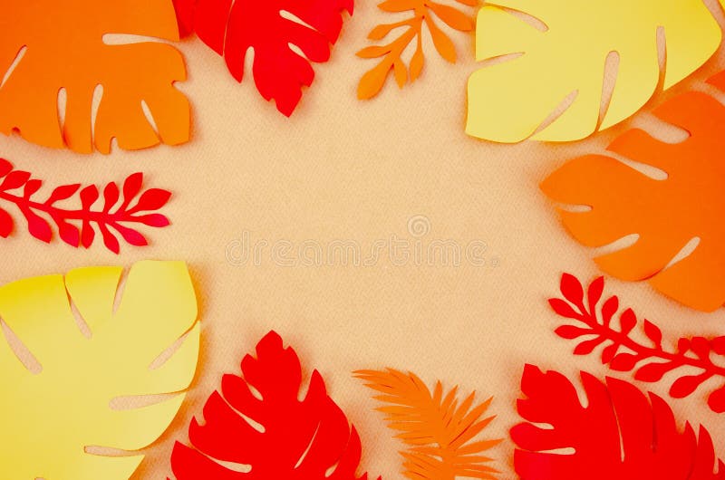 Top view various colorful Paper palm leaves frame on yellow background. Autumn is coming concept mockup with copy space royalty free stock photo
