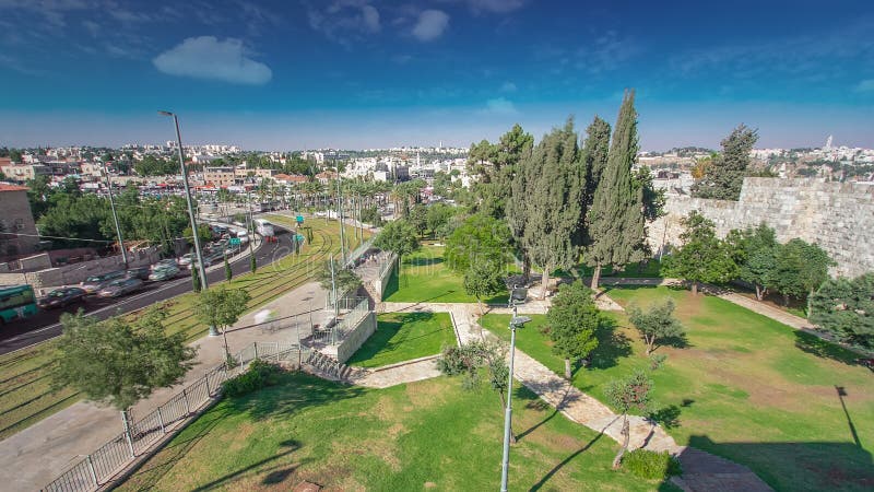 View from the wall to Jerusalem Old Town timelapse with Modern tram and traffic on the road. Jerusalem, Israel.