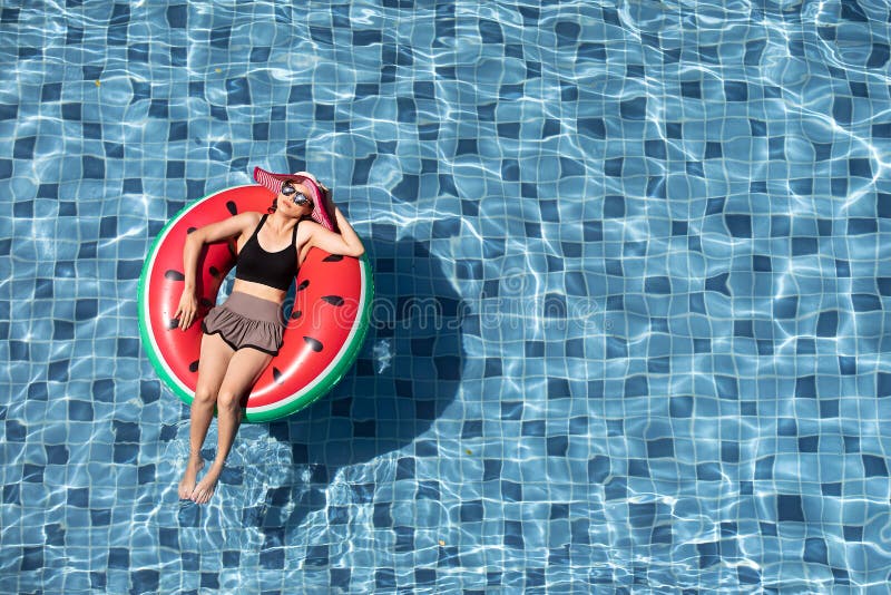 Top view of woman lay on balloon in pool