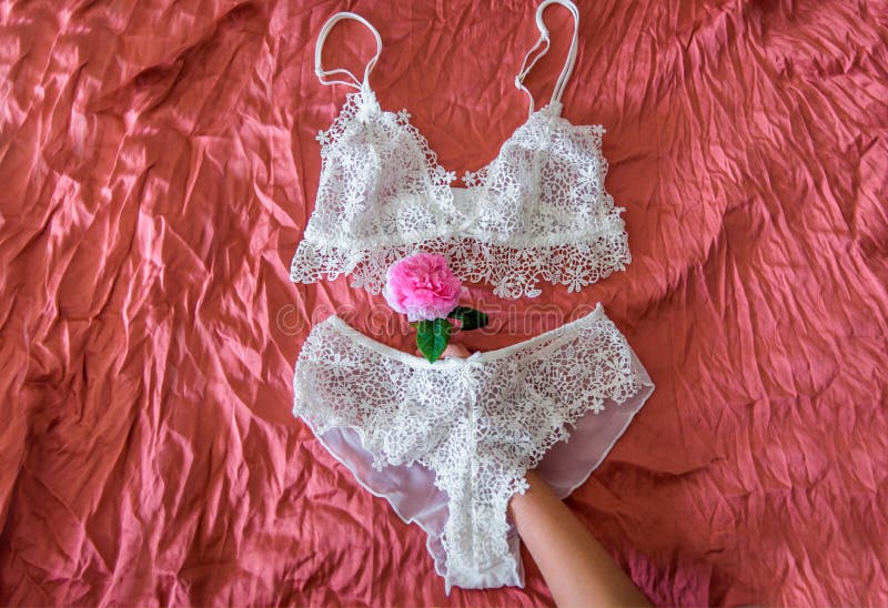 Woman`s Bra on Unmade Bed.Openwork White Cotton Underpants on Crumpled