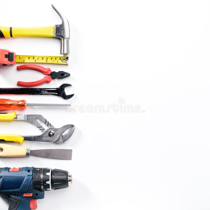 Top view of Working tools,wrench,socket wrench,hammer,screwdriver,plier,electric drill,tape measure,machinist square on white