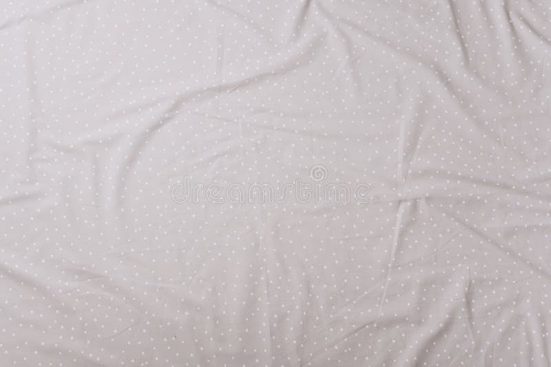 Top View of Wrinkles on Beige Spotted Bed Sheet. Bed Linen Texture