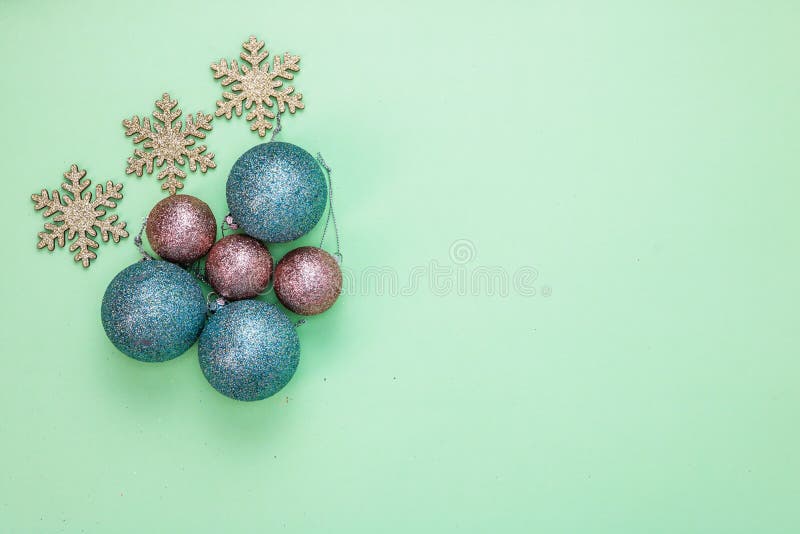 Toppvy av glittery snowflakes färgstarka julbullar som isolerats på den gröna bakgrunden royaltyfri fotografi