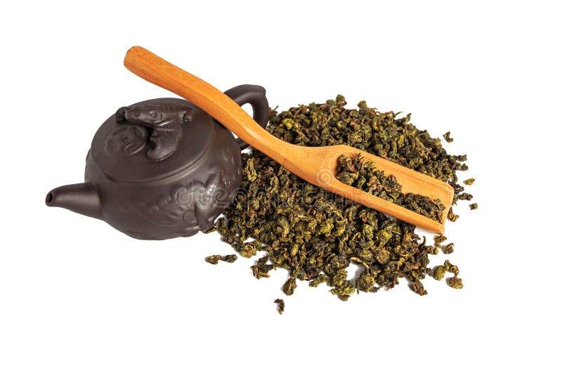 Torka sidor av tetieguanyin, spridda runt om en porslintekanna, ett teblad royaltyfri foto Torka sidor av tetieguanyin, spridda runt om en porslintekanna, ett teblad royaltyfri foto