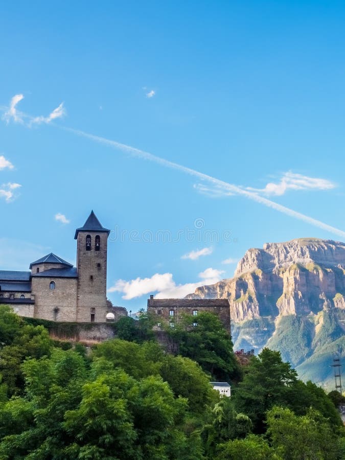 Torla Ordesa, church with the mountains at bottom, Pyrenees Spain vertical royalty free stock photo Torla Ordesa, church with the mountains at bottom, Pyrenees Spain vertical royalty free stock photo