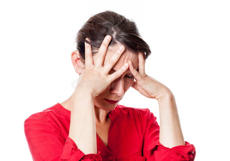 Tormented young woman touching her forehead with anxiety stock photo Tormented young woman touching her forehead with anxiety stock photo