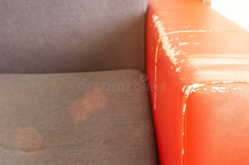Torn and Battered Leather Back of the Sofa. Poor Quality Leather