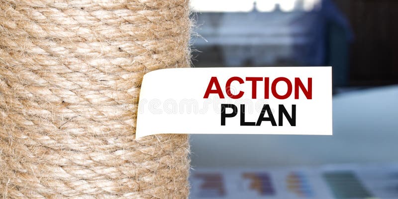 Torn brown paper on white surface with text ACTION PLAN royalty free stock photo