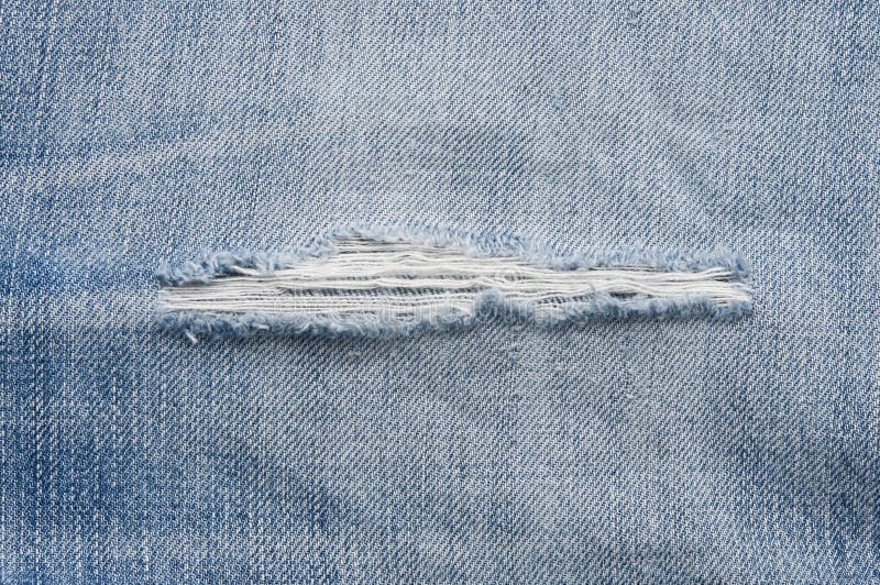 Torn jeans closeup royalty free stock image