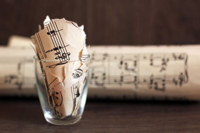 April 20, 2019. Izhevsk, Russia. Torn musical notes in a glass, pieces of paper royalty free stock photos