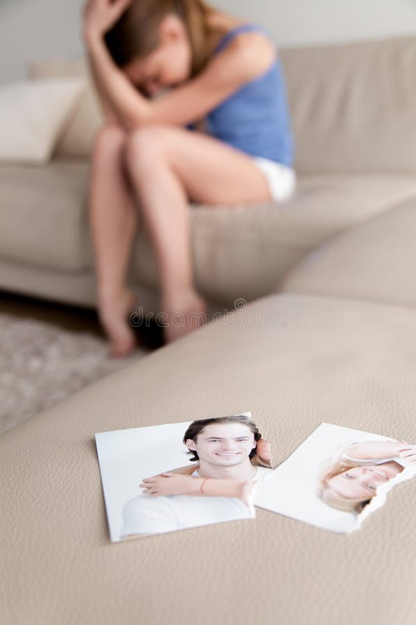 Torn photo of happy couple, crying desperate woman at background stock photo Torn photo of happy couple, crying desperate woman at background stock photo