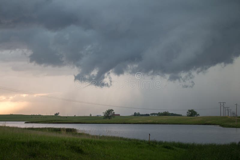 A Tornado Forms Beneath A Supercell Storm With Funnel Cloud Extending
