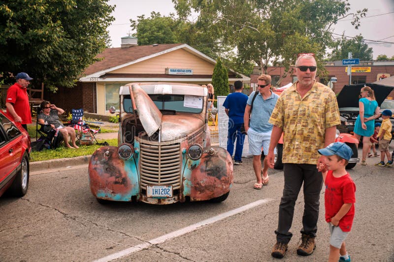 TORONTO, CANADA - 08 18 2018: Visitors of the open air auto show Wheels on the Danforth beside oldtimer car - 1939 Chevrolet pikup truck, owned by R. Robinson of Beamsville, Ontario