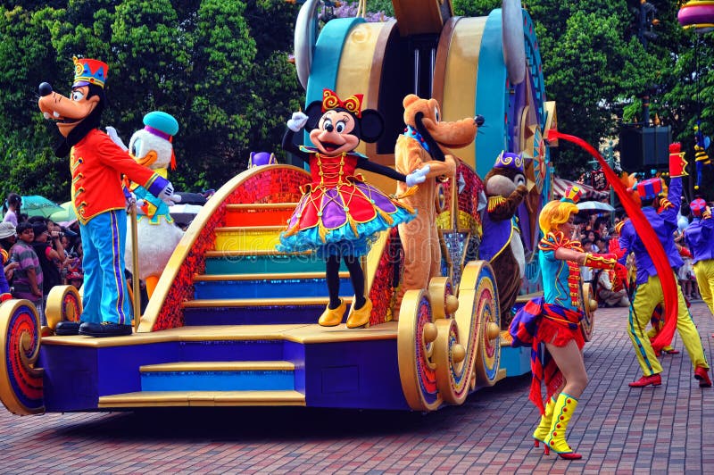 Disney cartoon characters goofy, donald duck, pluto, dale and minnie mouse along with other performers in colorful outfits greets visitors during the famous parade at disneyland. location : disneyland, hong kong. Disney cartoon characters goofy, donald duck, pluto, dale and minnie mouse along with other performers in colorful outfits greets visitors during the famous parade at disneyland. location : disneyland, hong kong