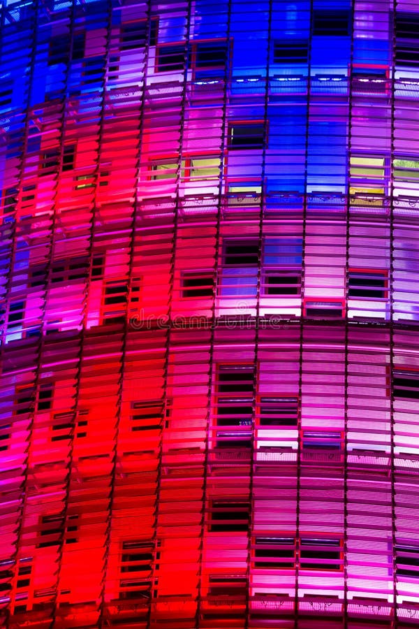 Closeup view of the Torre Agbar skyscaper, illuminated with color at night, Barcelona, Spain, Europe