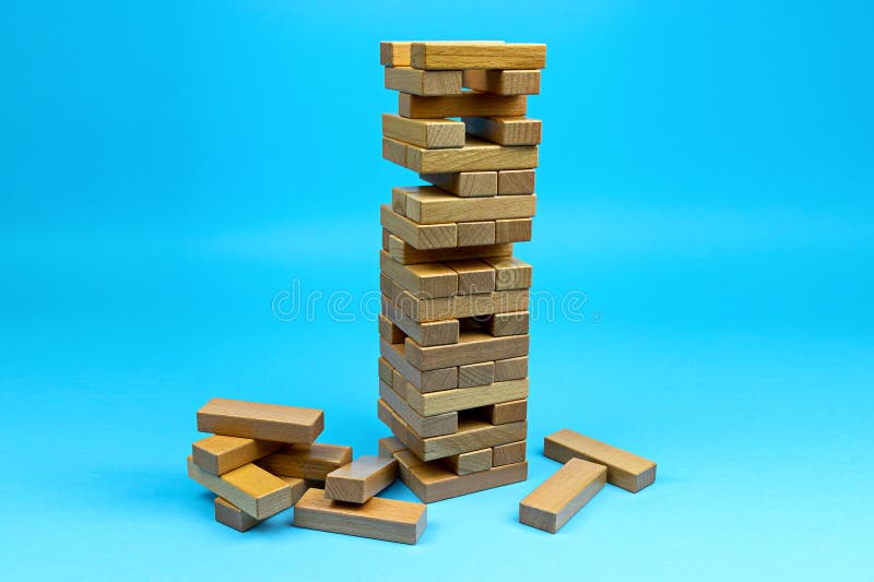 Wooden blocks tower. Building collapse games with family and friends. Leisure time. Risk management concept. Wooden blocks tower. Building collapse games with family and friends. Leisure time. Risk management concept.