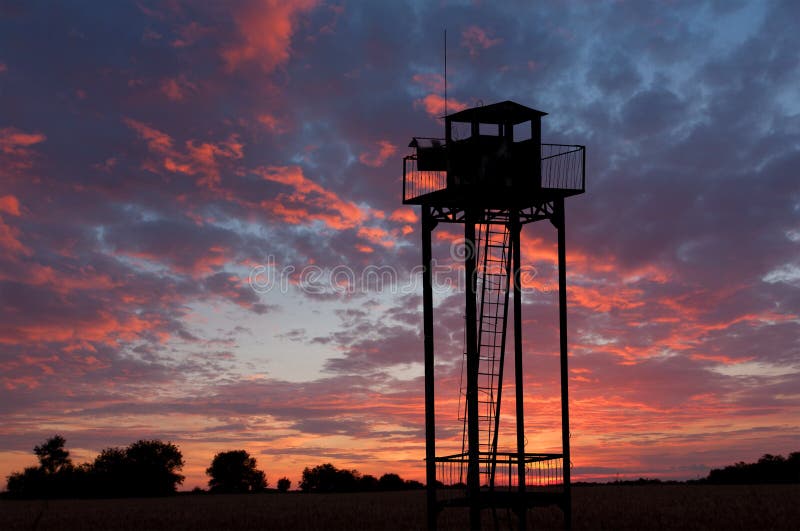 Torretta della vigilanza sul cielo di tramonto immagine stock Torretta della vigilanza sul cielo di tramonto immagine stock