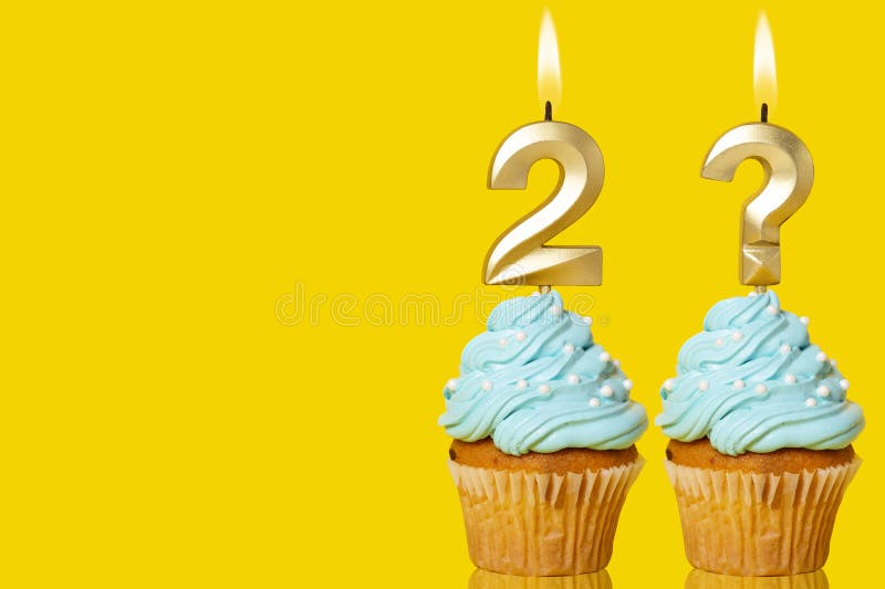 Birthday cake with lit Number 2 and Question Mark candle - Photo on Yellow background. Birthday cake with lit Number 2 and Question Mark candle - Photo on Yellow background