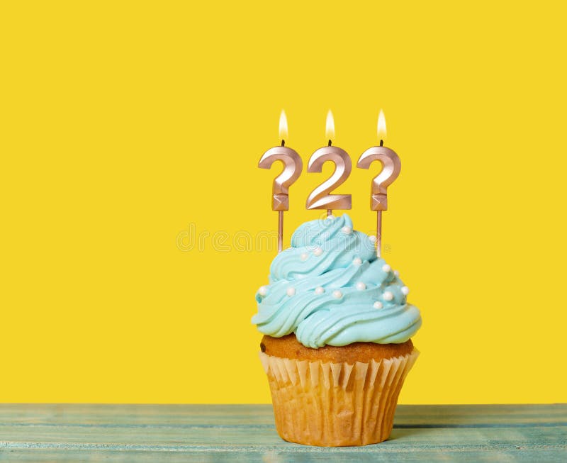 Birthday Cake With Candle Question Mark Number 2 And Question Mark - On Yellow Background. Birthday Cake With Candle Question Mark Number 2 And Question Mark - On Yellow Background.