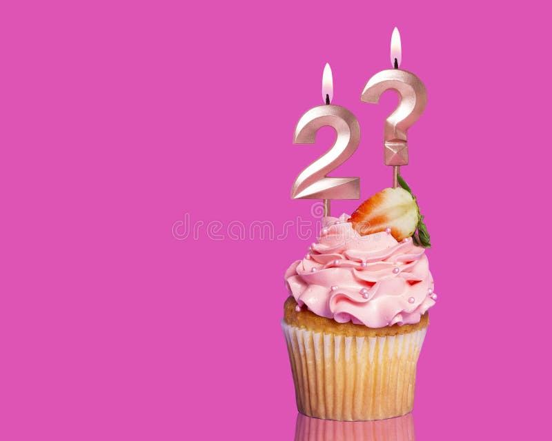 Birthday Cupcake With Candle Number 2 And Question Mark - On Hot Pink Background. Birthday Cupcake With Candle Number 2 And Question Mark - On Hot Pink Background.