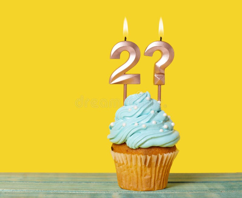 Birthday Cupcake With Candle Number 2 And Question Mark - On Yellow Background. Birthday Cupcake With Candle Number 2 And Question Mark - On Yellow Background.
