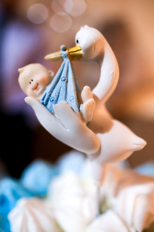 Cake decoration of a stork carrying a baby used as baby shower decoration. Cake decoration of a stork carrying a baby used as baby shower decoration