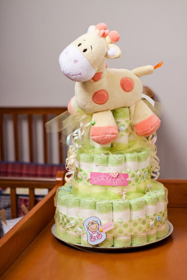 Green diaper cake for girl with yellow stuffed giraffe. Green diaper cake for girl with yellow stuffed giraffe