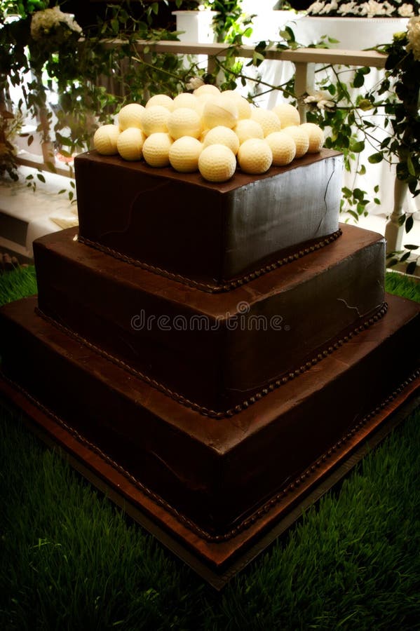 An image of a decadent chocolate groom's cake topped with white chocolate golf balls. An image of a decadent chocolate groom's cake topped with white chocolate golf balls