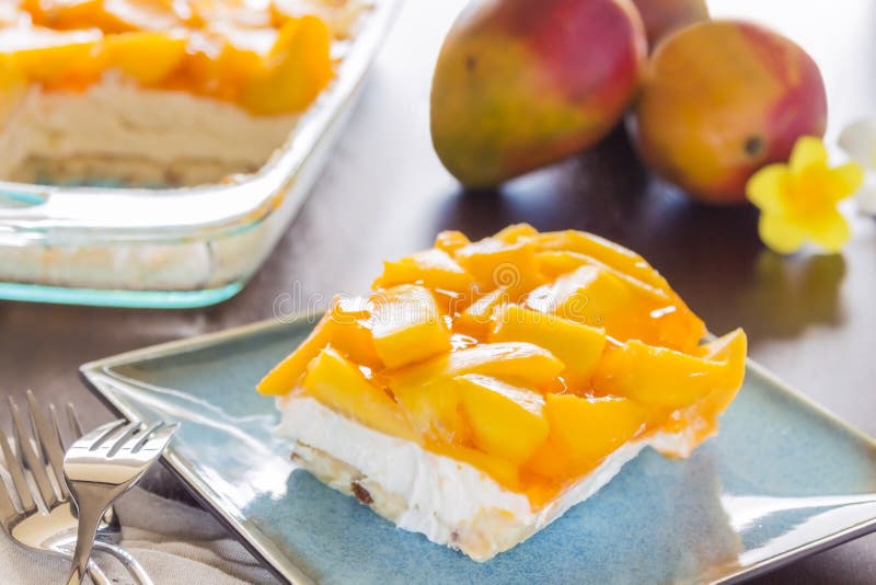 Decadent cheesecake topped with fresh mango and orange jello with macadamia nut crust. Decadent cheesecake topped with fresh mango and orange jello with macadamia nut crust