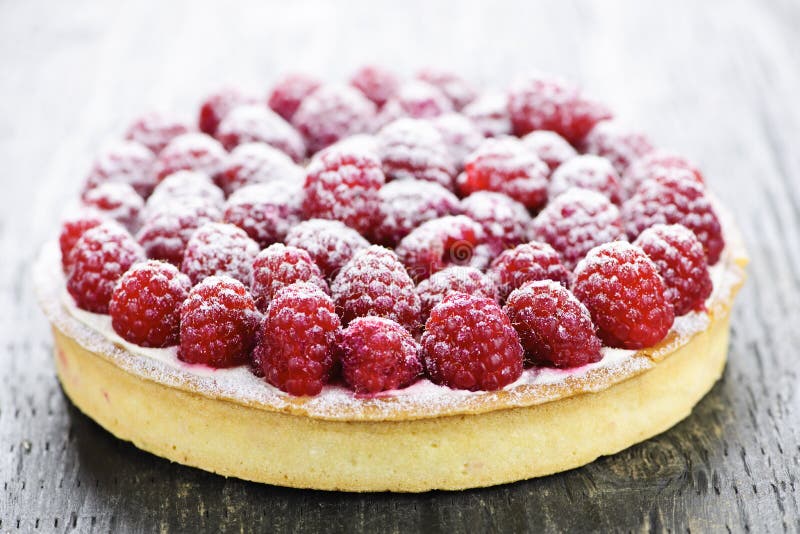 Fresh dessert fruit tart covered in raspberries. Fresh dessert fruit tart covered in raspberries