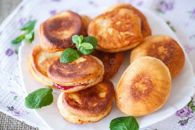 Fried cakes with jam decorated with mint. Fried cakes with jam decorated with mint