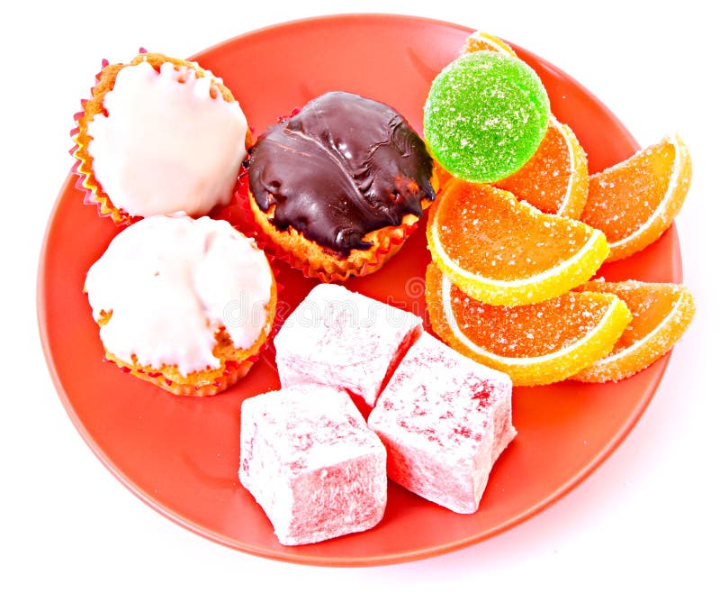 Selection of sweets and cakes on plate, isolated on white background. Selection of sweets and cakes on plate, isolated on white background.