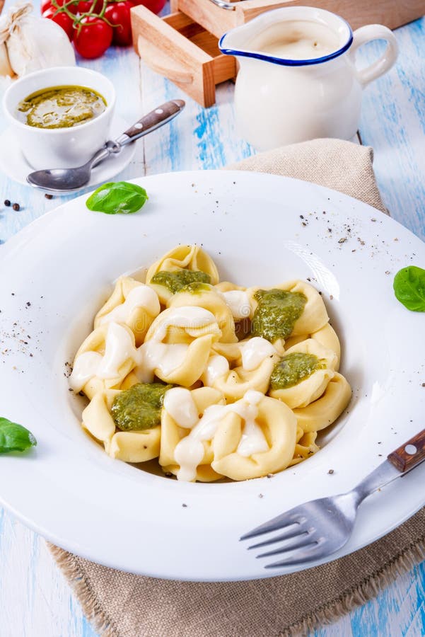 A Tortellini Di Formaggio with Basil Pesto and Cheese Sauce Stock Image